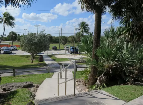 Lovely beach with thin ribbon of sand backed by high walls of dunes, and across the street, a playground with white sand and swings.