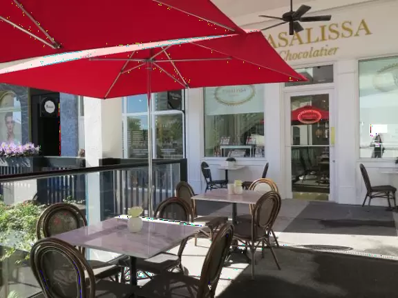 Ultra rich outdoor mall with gorgeous plants, fountains, sculptures, and flowers.