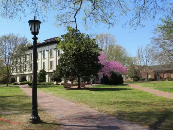 Historic buildings, sunny quad where students hang out, flowers and old trees, and fun student center area.