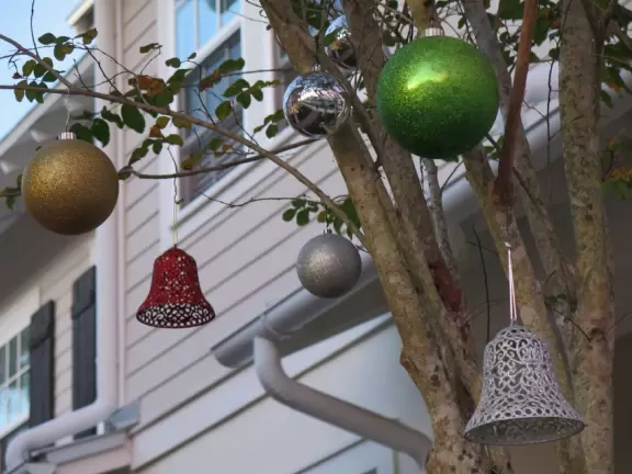 A popular town center with sidewalk cafes leading down to a pretty lake with a walking path.