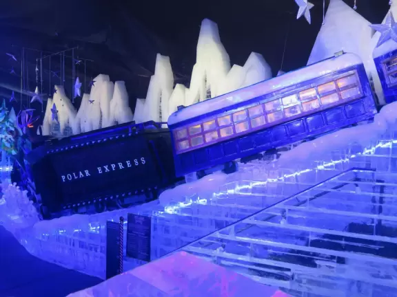 Hotel inside a giant atrium with tropical plants, fish, alligators, and decorations. ICE sculpture event in December.