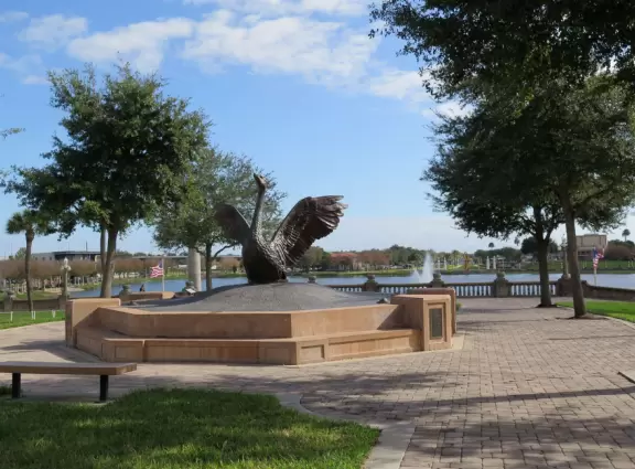 Beautiful garden with many partitioned areas, tropical plants, flowers, all with the blue lake behind. Plus, promenade around the lake.