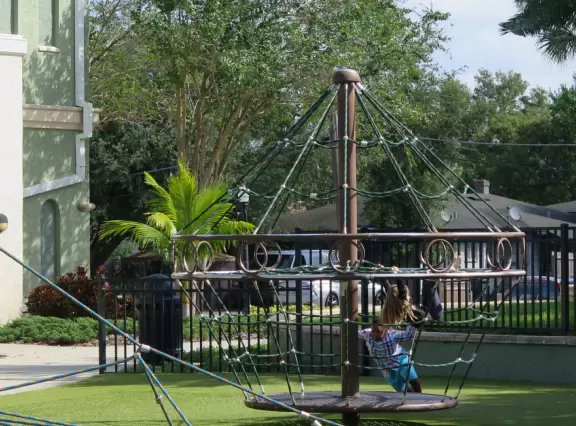 Beautiful garden with many partitioned areas, tropical plants, flowers, all with the blue lake behind. Plus, promenade around the lake.