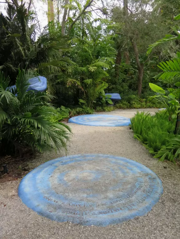Lush paradise with water lilies galore, rustling bamboo, stone bridge, tropical flowers, strangler fig, and a gorgeous royal palm grove.