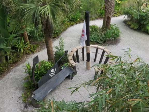 Lush paradise with water lilies galore, rustling bamboo, stone bridge, tropical flowers, strangler fig, and a gorgeous royal palm grove.