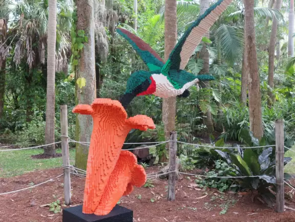 Lush paradise with water lilies galore, rustling bamboo, stone bridge, tropical flowers, strangler fig, and a gorgeous royal palm grove.