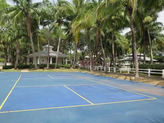 Tropical park with sky-high playground for older kids, toddler playground, fitness trail and stations, pale-lime gazebo, and spiffy basketball courts.