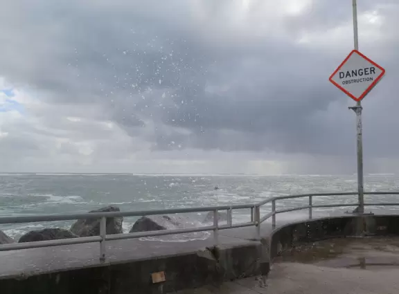 Beach where fishermen hang out on the jetty and surfers come to ride the waves at Jupiter Inlet.