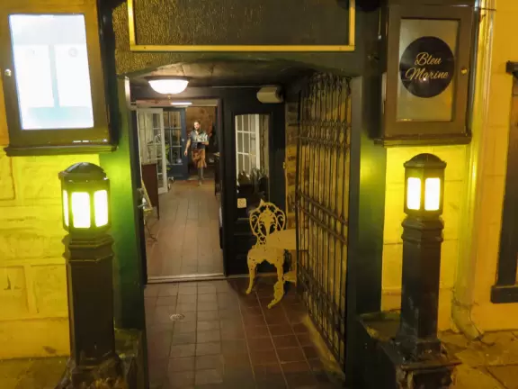Very crowded street of historic buildings with restaurants and hotels, leading down to Chateau Frontenac.