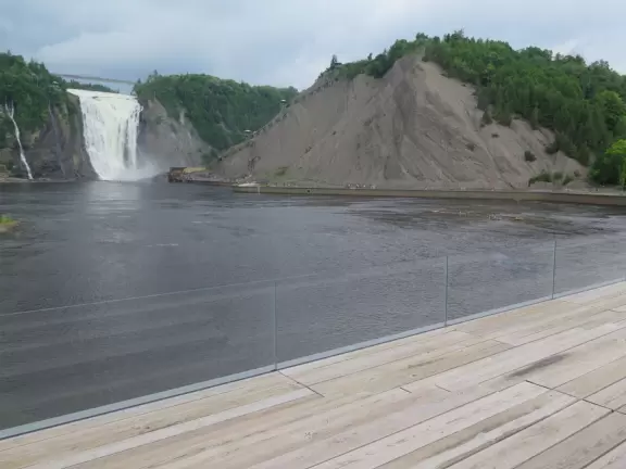 Tall waterfall at the mouth of the Montmorency River. You can walk stairs up to a suspension bridge over the falls.