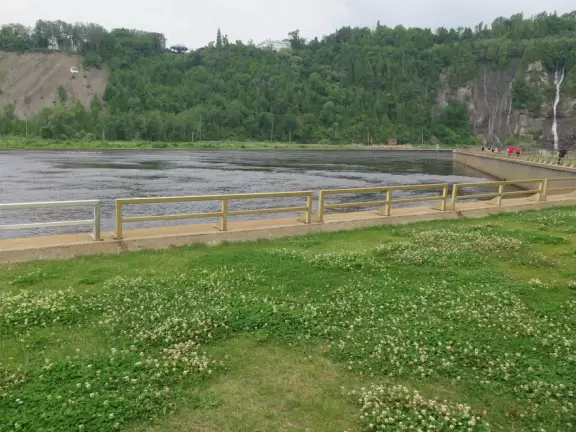 Tall waterfall at the mouth of the Montmorency River. You can walk stairs up to a suspension bridge over the falls.