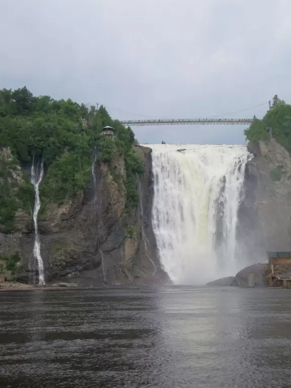 Tall waterfall at the mouth of the Montmorency River. You can walk stairs up to a suspension bridge over the falls.