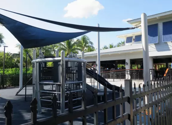 Large lagoon with clear water where kids can swim, tons of shade, and playground in the sand.