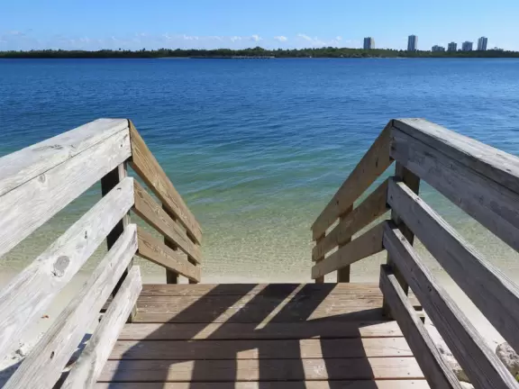 Gorgeous park with white sand beaches, ironwood trees, beach sunflowers, playground, basketball, and a pretty walkway.