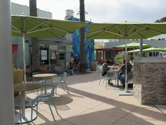 Shopping plaza near UCSD with Mendocino Farms cafe, Whole Foods market, Cava Bowls, Rubio's Coastal Grill, Philz Coffee, and some nice murals.