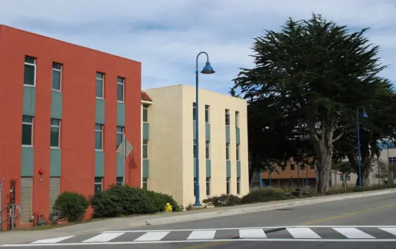 Spooky campus with mix of ultra-modern buildings and derelict military barracks.