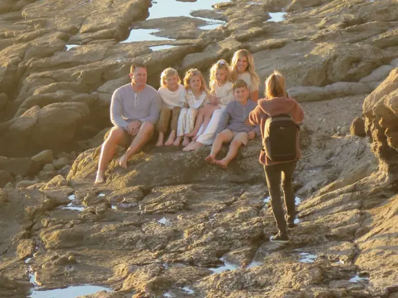 Formal photos of a family, at the tide pools. 