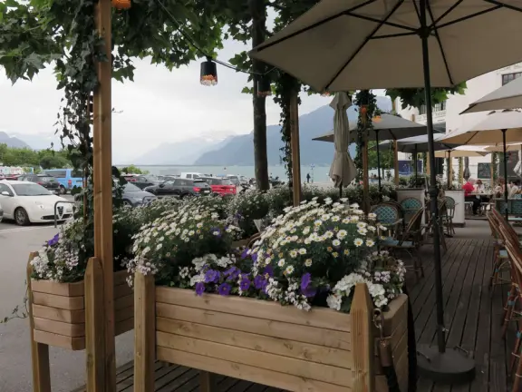 Beautiful waterfront walking path with flower beds, giant fork sculpture on the water, food museum with interesting garden, and square with historic buildings and cafes.