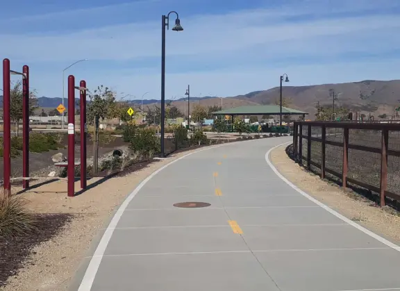 Neighborhood with huge playground, second playground with picnic pavilion, flowers, creek, and short bike path kids can tricycle along.