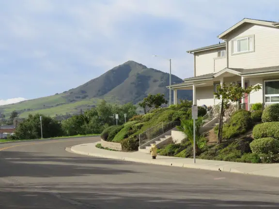 Bike path with views of hills all around, and pretty neighborhood nearby.