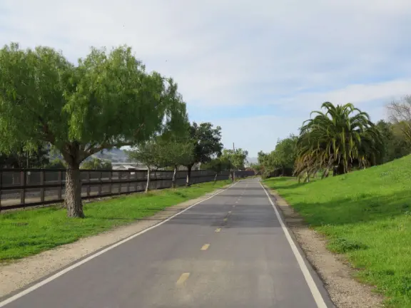 Bike path with views of hills all around, and pretty neighborhood nearby.