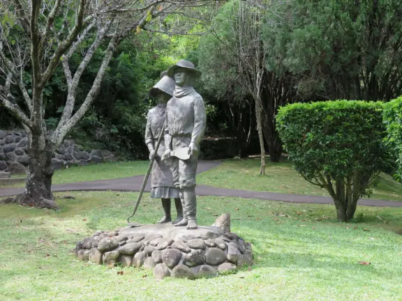 A gorgeous public garden under high mountain ridges, with dwellings representing the many cultures that are found in Maui: Portuguese, Chinese, Japanese, Filipino, Hawaiian, and New England.