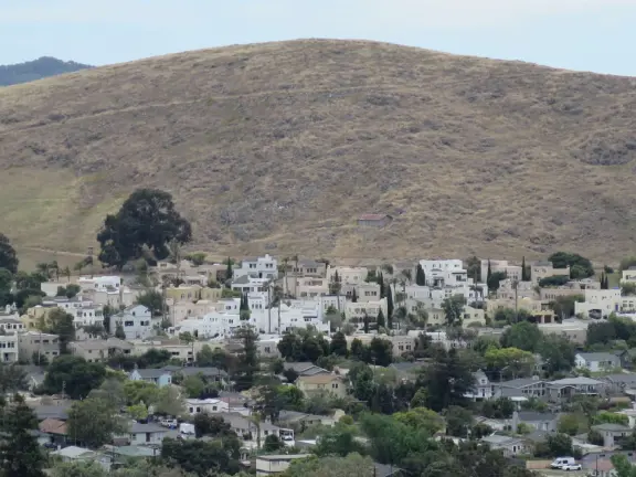 Hilltop park with basketball court with views, picnic tables, eucalyptus trees, and a difficult two-mile out-and-back trail.