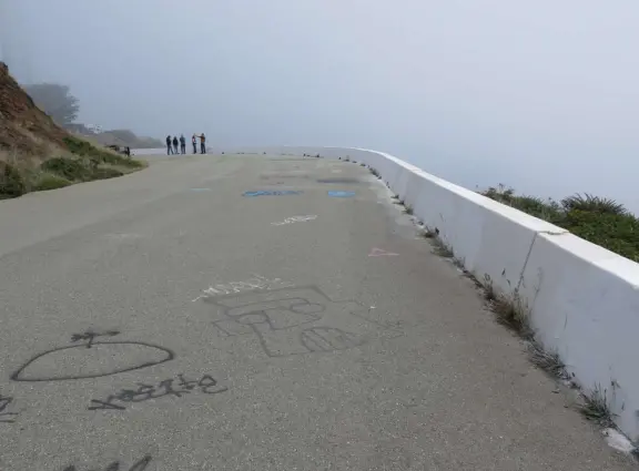 Views of sprawl, between two dry, barren hills. Steps to the top of each hill. Windy. Extremely foggy in the morning.