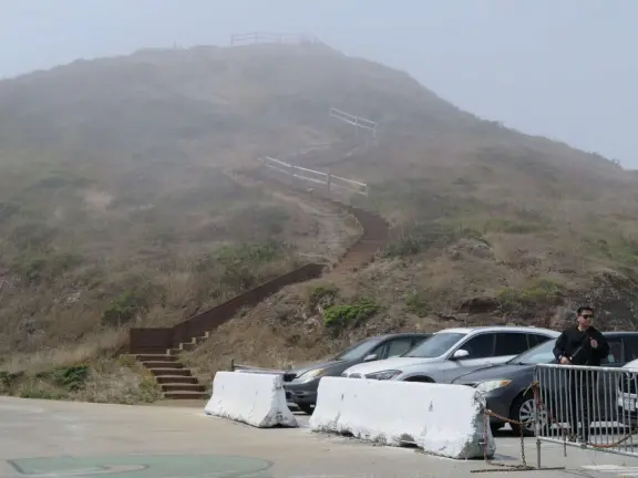 Views of sprawl, between two dry, barren hills. Steps to the top of each hill. Windy. Extremely foggy in the morning.