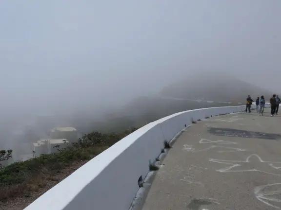 Views of sprawl, between two dry, barren hills. Steps to the top of each hill. Windy. Extremely foggy in the morning.