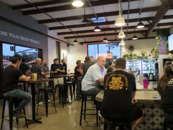 Trendy area with coffee shop, beer garden, wine bars, and cider bar, in industrial-style architecture with murals.