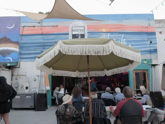 A main street of late 19th century storefronts, popular cafes, and a hip college scene. Recently, suffering an epidemic of homelessness relating to mental health problems.