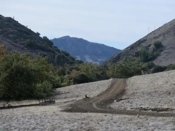 Wonderful wide open spaces with mountains of all shapes and sizes! First mile is shady. Four mile out and back, or five mile lollipop loop hike. Optional detours: architecture creations, or mountaintop swing.