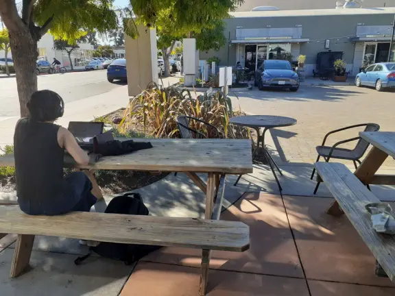A main street of late 19th century storefronts, popular cafes, and a hip college scene. Recently, suffering an epidemic of homelessness relating to mental health problems.