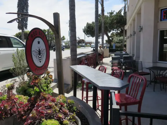 Cute area on Grand Avenue with colorful sidewalk, palm trees, ocean air, and a few good cafes.