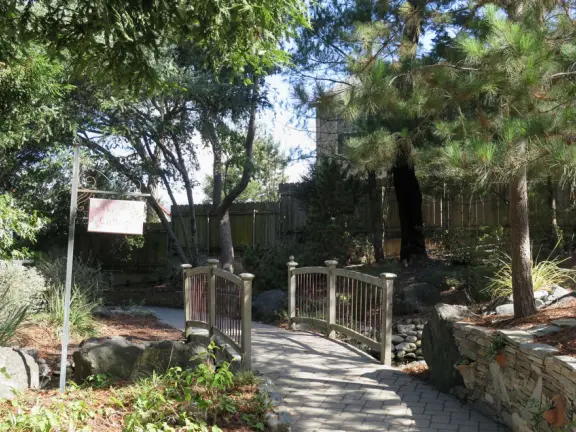 Garden in a sunny, sheltered spot, with cottage with turret under redwood trees, Buddhist gazebo, goats, and flowers galore! Seasonal pumpkins and Christmas market!