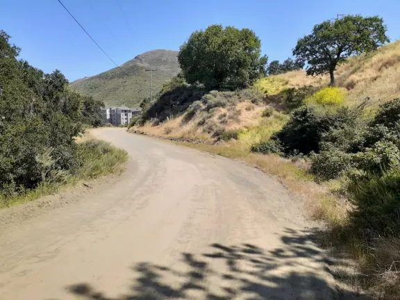 Wonderful wide open spaces with mountains of all shapes and sizes! First mile is shady. Four mile out and back, or five mile lollipop loop hike. Optional detours: architecture creations, or mountaintop swing.