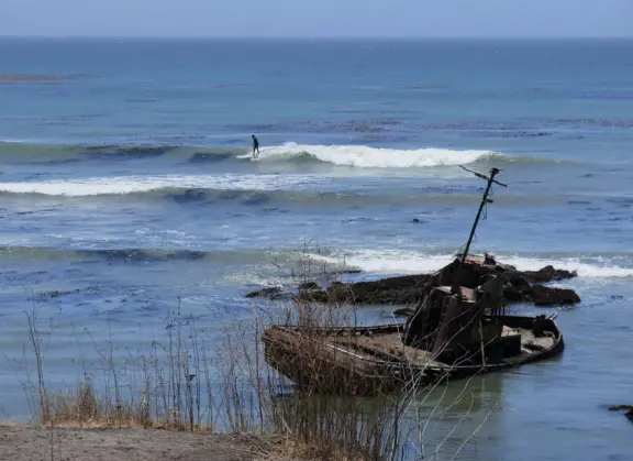 A memorable walk is along the clifftop trail at Estero Bluffs, with the wide open spaces, beach below with shiny green agate rocks, and shipwreck!