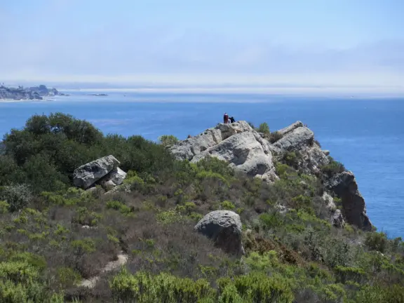 Warm, sheltered cove below Smuggler's Cave. Steep climb down.