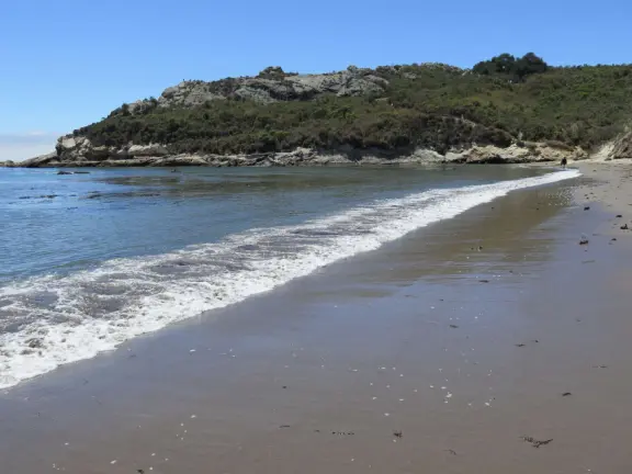 Warm, sheltered cove below Smuggler's Cave. Steep climb down.