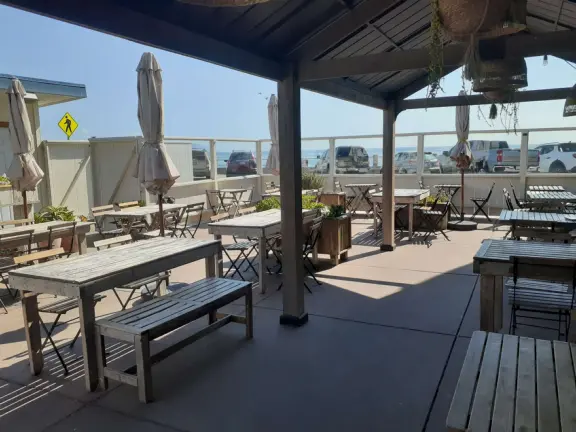 A pretty beachside town, with a wooden pier and wide windy beach with perfect views of Morro Rock, and colorful houses with gardens, backed by gently-sloping hills.