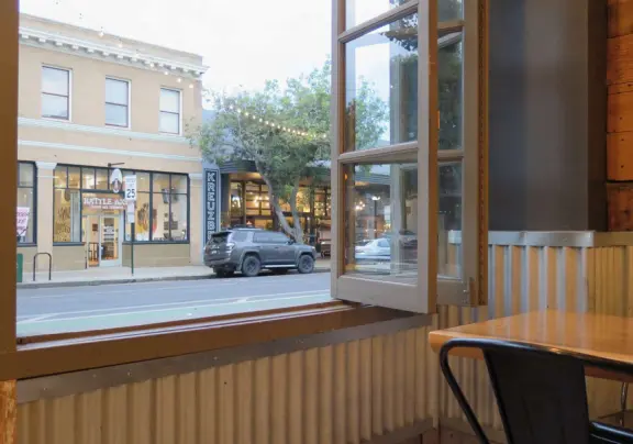 A main street of late 19th century storefronts, popular cafes, and a hip college scene. Recently, suffering an epidemic of homelessness relating to mental health problems.