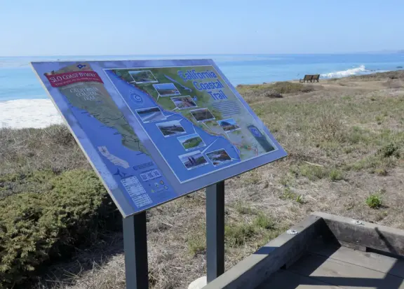 Rugged, windswept beach with large driftwood, kelp balls, and 1.5km wooden boardwalk.