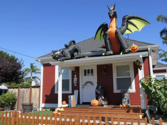 Large lush park with tall tropical trees, attractive bandstand, cute toddler playground, historic house and schoolhouse, swinging bridge to the main street, and neighborhood with cottages.