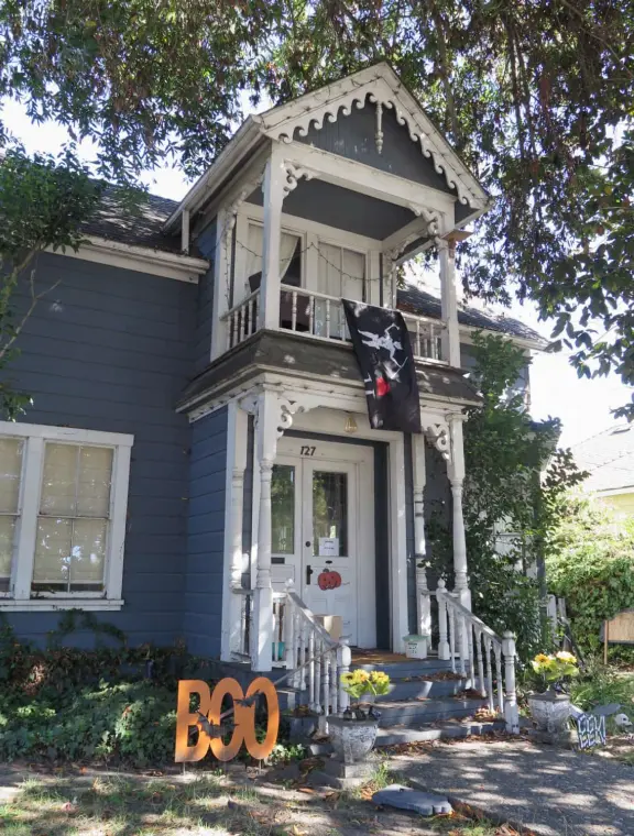 Large lush park with tall tropical trees, attractive bandstand, cute toddler playground, historic house and schoolhouse, swinging bridge to the main street, and neighborhood with cottages.