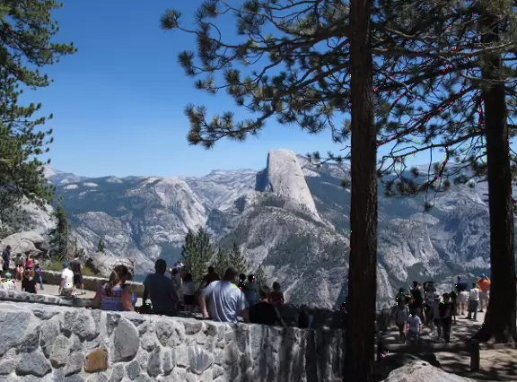 Breathtaking side-on view of half dome, three waterfalls, and the entire stunning valley.