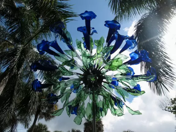 Lush paradise with water lilies galore, rustling bamboo, stone bridge, tropical flowers, strangler fig, and a gorgeous royal palm grove.