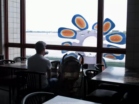 A dad with a stroller appreciates the view over the river.